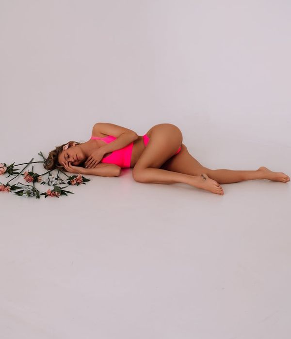 Woman in a dynamic yet graceful cardio pose in a studio with cyan accents.